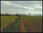 Walking across the fields from Nympsfield to Coaley Peak and the Cotswold Way .